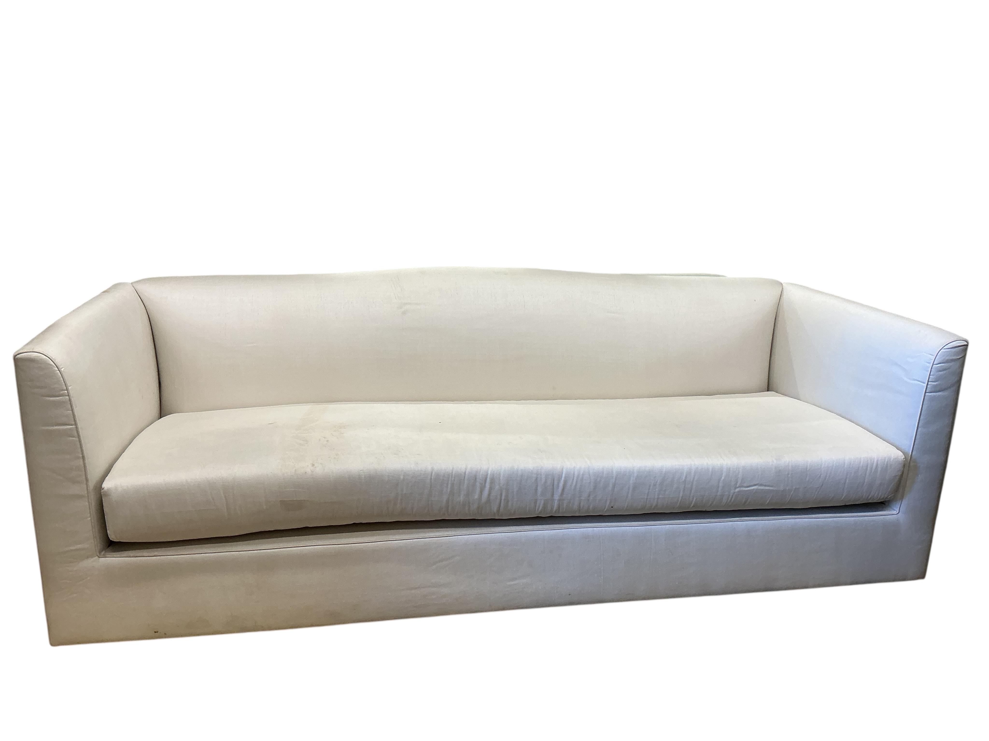 A large contemporary ivory fabric settee, width 260cm, depth 100cm, height 82cm